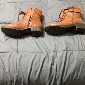 Boots with laces, zippers on side. Slight heel